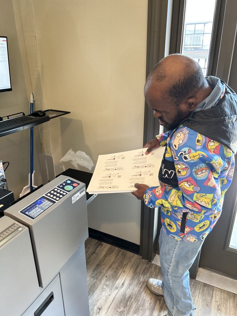 Larin working on the printer. 